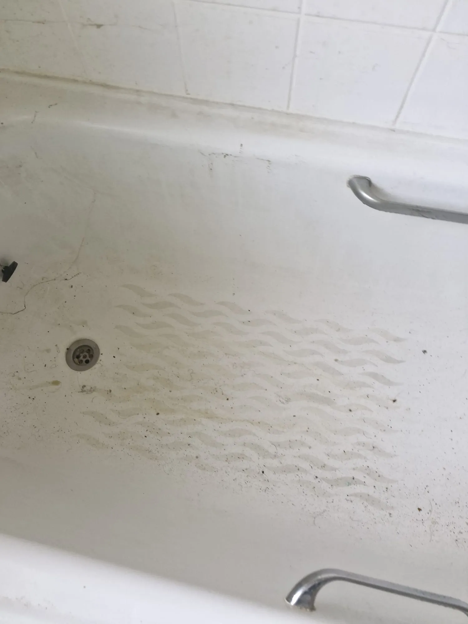 Before bathroom refurbishment preparation: bath area requiring specialist cleaning in Colchester