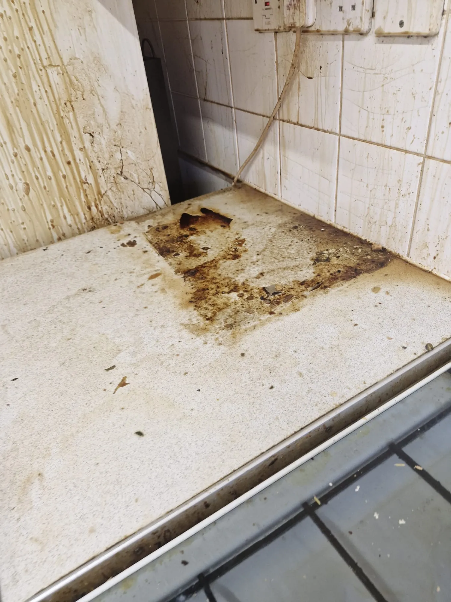 Before specialist pre-refurbishment cleaning: soiled kitchen worktop exposed in Colchester, Essex
